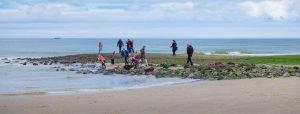 Family walking along a cold beach