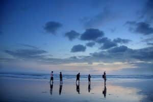 Family playing at beach in sunset