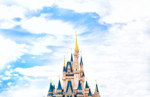 Top of Cinderella's Castle surrounded by blue sky and white clouds