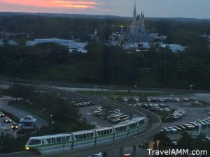 Monorail going towards the Contemporary Resort with the sun setting and the Magic Kingdom in the background