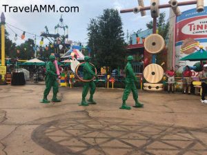 Marching Green Army Men in Toy Story Land. Giant footprint on ground shows size of guests.