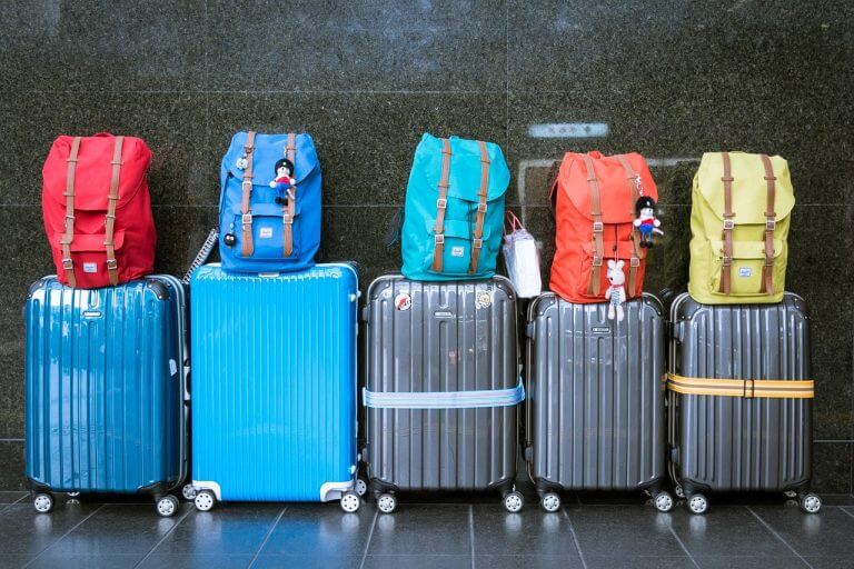 luggage lined up against a dark wall. TravelAMM.com