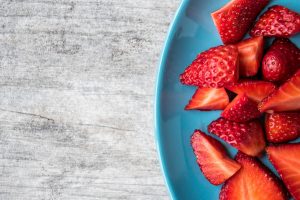 Plate of sliced strawberries.