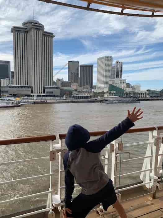 Child waving at shore on the Disney Magic out of New Orleans in March 2023