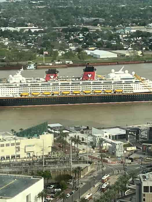 Disney Magic sailing down Mississippi River as seen from office building downtown
